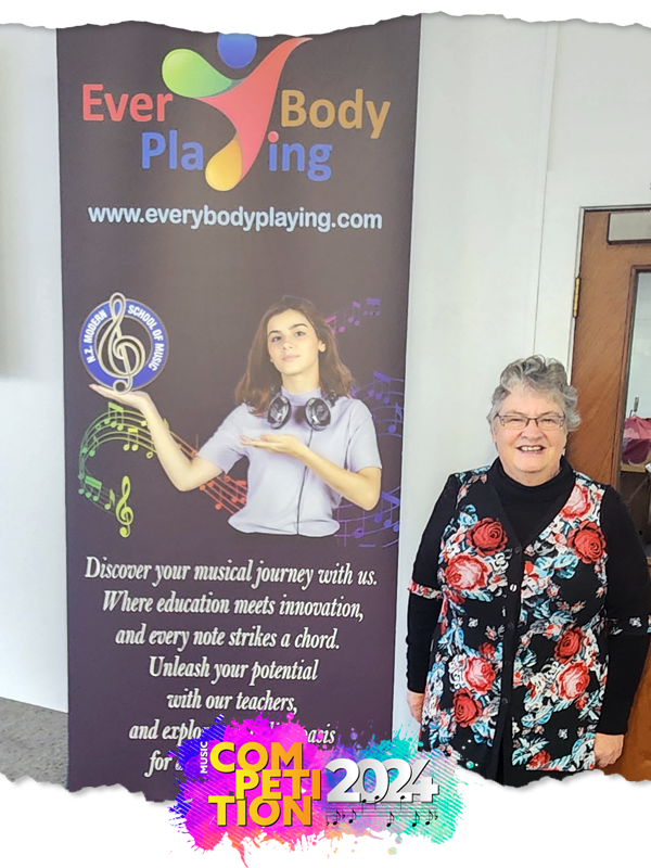 picture of miss gail in front school banner